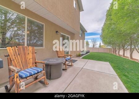 Patio reposant avec deux fauteuils à bascule en bois sur une dalle de béton Banque D'Images