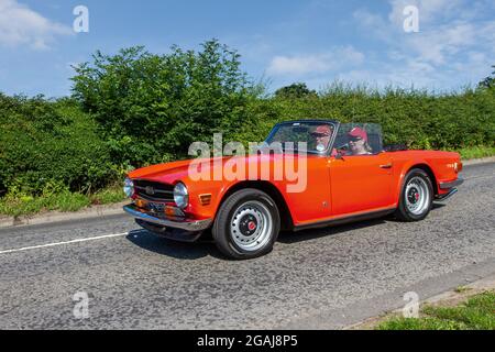 1972 70s soixante-dix rouge Triumph TR6 2498cc essence voiture de sport britannique en route vers Capesthorne Hall Classic July car show, Cheshire, Royaume-Uni Banque D'Images