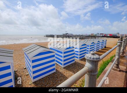 Hastings Pier et des cabanes de plage sur Haslings Beach, Hasstling, East Sussex, Royaume-Uni Banque D'Images