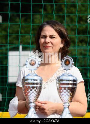 Potsdam, Allemagne. 1er août 2021. Annalena Baerbock, candidate à la chancelière et première candidate de Bündnis 90/Die Grünen, se dresse derrière deux trophées de fair-play lors du tournoi de football pour les jeunes 're:start'. Le tournoi 're:start Street Soccer Championship' est organisé par la Brandenburg Sports Youth. L'objectif est d'amener les enfants et les jeunes à se déplacer à nouveau après la pandémie et d'inspirer les enfants d'un large éventail de familles à adopter le sport de club. Credit: Soeren Stache/dpa-Zentralbild/dpa/Alay Live News Banque D'Images