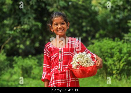 Dhaka, Bangladesh. 1er août 2021. Un enfant de la rue, Jinia Akther, âgé de 10 ans, vend des fleurs à l'Université de Dhaka, au Bangladesh. Crédit : SOPA Images Limited/Alamy Live News Banque D'Images