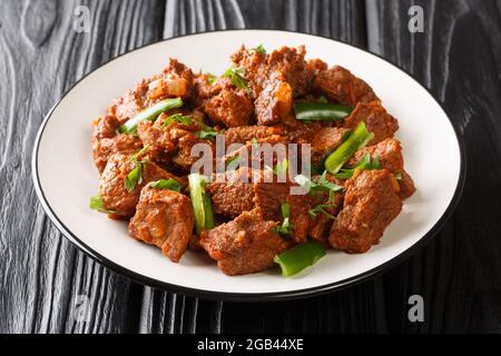 Plat africain Tibs à base de bœuf rôti dans une sauce végétale épicée aux épices berbères dans une assiette sur la table. Horizontal Banque D'Images