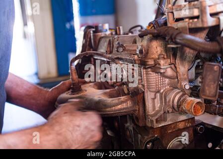 Détail de la révision du moteur de voiture par le mécanicien dans un atelier Banque D'Images