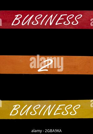Business 2 texte d'affaires sur des bâtons de couleur disposés de haut en bas sur fond noir Banque D'Images