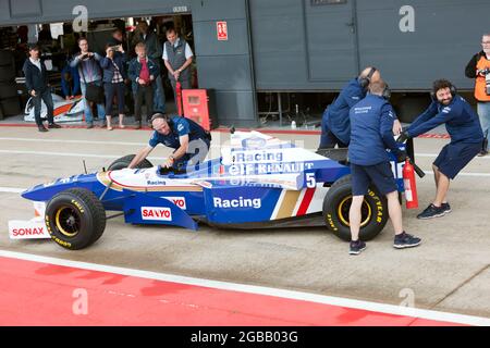 Les membres de l'écurie Williams Racing Team, remportant le championnat de Damon Hills, Williams FW18 Formula One car au garage de la fosse de Silverstone Banque D'Images