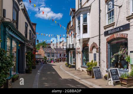 Vue sur les magasins et les cafés de Kirkgate, Ripon, North Yorkshire, Angleterre, Royaume-Uni, Europe Banque D'Images