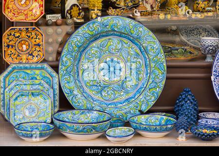 Taormina, Messine, Sicile, Italie. Vaisselle en céramique accrocheuse exposée à l'extérieur d'une boutique de souvenirs et d'artisanat typique dans la via Teatro Greco. Banque D'Images