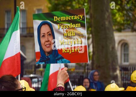 Londres, Royaume-Uni. 3 août 2021. Un manifestant tient un écriteau pro-démocratie avec une photo de Maryam Rajavi. Des membres de la communauté anglo-iranienne et des partisans du Conseil national de la résistance de l'Iran (NCRI) se sont rassemblés devant Downing Street pour condamner le régime du président Ebrahim Raisi et souligner le massacre de 30,000 prisonniers politiques en Iran en 1988. (Crédit : Vuk Valcic/Alamy Live News) Banque D'Images