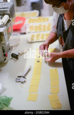 PIACENZA, ITALIE - 17 juillet 2021 : une photo verticale d'une femelle préparant Tortelli - pâtes italiennes traditionnelles fourrées à Piacenza, Italie Banque D'Images