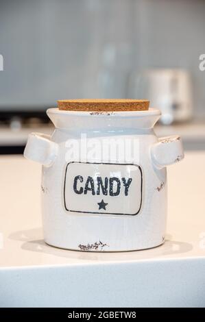 Pot de bonbons blanc en céramique dans une cuisine moderne avec un fond flou. Banque D'Images