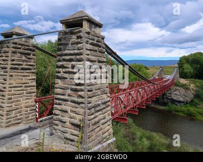 Le pont suspendu d'Ophir est un pont rouge classique à sens unique construit pendant la ruée vers l'or de l'Otago central, dans l'île du Sud, en Nouvelle-Zélande Banque D'Images