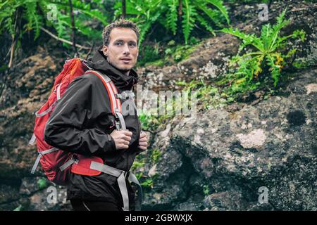 Randonneur randonnée dans la forêt tropicale printemps automne saison. Randonneur mâle regardant loin marcher dans la forêt en plein air sentier de nature. Modèle mâle caucasien activé Banque D'Images