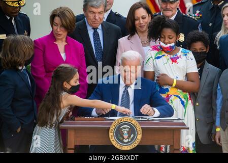 Abigail Evans, fille du policier du Capitole tué William âBillyâ Evans, aide le président des États-Unis Joe Biden à signer le H.R. 3325, âAn Act pour remettre quatre médailles d'or au Congrès à la police du Capitole des États-Unis et à ceux qui ont protégé le Capitole des États-Unis le 6 janvier, 2021,â en droit dans le jardin des roses de la Maison Blanche à Washington, DC, le jeudi 5 août 2021. Crédit : Rod Lamkey/CNP Banque D'Images