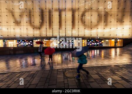 Tokyo, Japon. 28 octobre 2016. Les gens qui se cachent de la pluie sous des parasols marchent devant un magasin Louis Vuitton à Roppongi. (Image de crédit : © Damon Coulter/SOPA Images via ZUMA Press Wire) Banque D'Images
