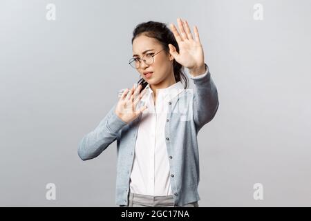 Les gens, les émotions et le concept de style de vie. Portrait de la femme asiatique dégoûtée et dégoûtée se défendant de quelqu'un toussant près d'elle, tour à tour Banque D'Images