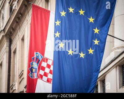 Photo des drapeaux de la Croatie et de l'UE qui se sont fait l'air devant un bâtiment. L'élargissement de l'Union européenne en 2013 a vu la Croatie rejoindre le Banque D'Images