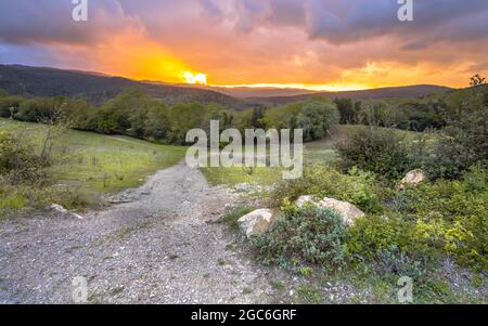 Magnifique coucher de soleil sur le paysage vallonné de Toscane, Italie, avril. Banque D'Images