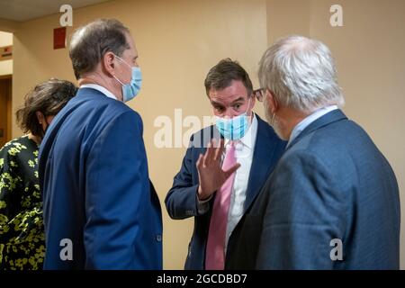 Le sénateur américain Mark Warner (démocrate de Virginie), au centre, s'entretient avec le sénateur américain Ron Wyden (démocrate d'Oregon), a quitté et deux autres dans le sous-sol du Capitole des États-Unis lors d'un vote à Washington, DC, le samedi 7 août 2021. (Photo de Rod Lamkey / CNP/Sipa USA) Banque D'Images