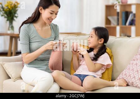 Bonne mère et fille tricoter à la maison Banque D'Images