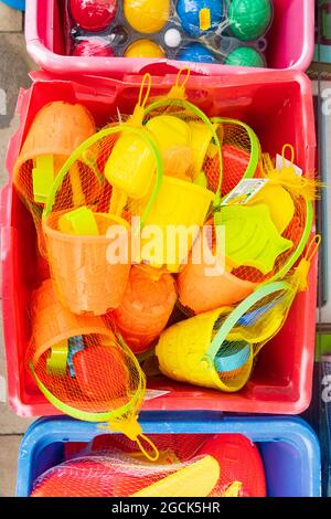Seau en plastique coloré pour enfants et jouets de plage en pelle dans le Scarborough Yorkshire Banque D'Images