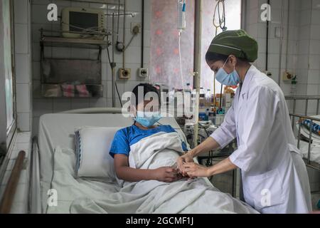 Dhaka, Bangladesh. 09e août 2021. Une infirmière s'occupe d'une fille qui a été infectée par la dengue à l'hôpital pour enfants. Le Bangladesh combat l'épidémie de dengue dans le contexte de la crise de la COVID, une forte augmentation des cas de dengue souche le système de santé du Bangladesh déjà frappé par une aggravation de la crise de la COVID dans le pays. Ce mois-ci, 1,920 personnes ont reçu un diagnostic de la maladie transmise par les moustiques, l'augmentation des patients infectés par la dengue à partir de juin ayant atteint 272 cas. Le 8 août 2021 à Dhaka, au Bangladesh. (Photo d'Eyepix/Sipa USA) crédit: SIPA USA/Alay Live News Banque D'Images