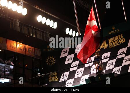 Le podium porte le drapeau danois à mi-mât pour rendre hommage à Allan Simonsen (DEN) Aston Martin Vantage V8, qui a subi un accident mortel dans la course. 24 heures du Mans, samedi 22 juin 2013. Le Mans, France. Banque D'Images