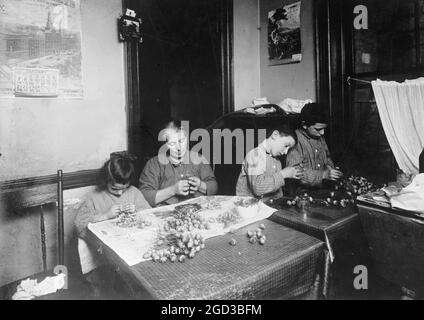 Faire des fleurs artificielles dans une maison de résidence de New York environ entre 1909 et 1919 Banque D'Images
