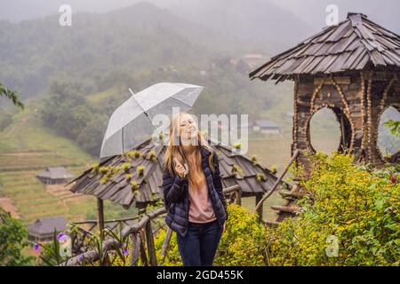 Femme touriste avec parapluie à Sapa dans le brouillard, nord-ouest du Vietnam. Concept de voyage au Vietnam. Patrimoine de l'UNESCO. Le Vietnam s'ouvre au tourisme après la quarantaine Banque D'Images