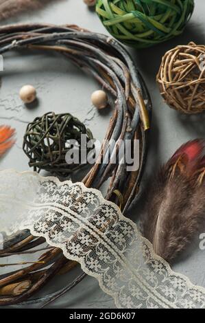 Décoration de bricolage avec anneau en osier, lacets, perles sur fond de béton. Mariage, Noël texture rugueuse plat. Assemblage de l'attrape-rêve Banque D'Images