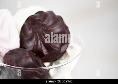 Guimauves au chocolat sur fond blanc, gros plan, horizontal Banque D'Images