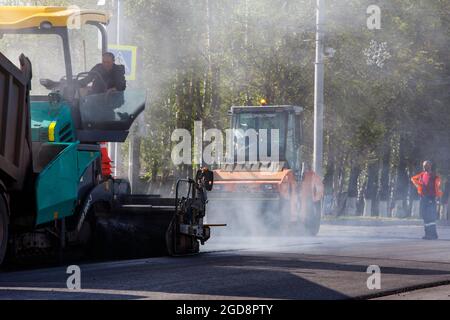 Tula, Russie - 16 mai 2021 : procédé d'asphaltage, machine à finisseur et deux rouleaux routiers pendant les travaux de construction de routes, travaillant sur la nouvelle route Banque D'Images