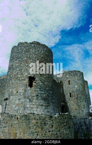 Château de Harlech, pays de Galles. Des murs défensifs impressionnants et spectaculaires avec deux tours. Plan vertical, fond bleu ciel, espace de copie. Patrimoine mondial de l'UNESCO. Banque D'Images