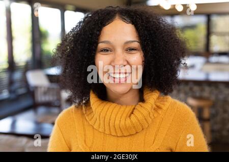 Portrait d'une heureuse femme de course mixte souriant et regardant l'appareil photo Banque D'Images