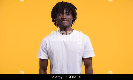 souriant heureux africain américain avec des dreadlocks isolés sur jaune Banque D'Images