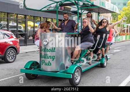 Detroit, Michigan - Happy Partiers sur un pub à pédales dans le centre-ville de Detroit. Les lois de l'État et de la ville permettent aux groupes de consommer leurs propres boissons alcoolisées à la pédale Banque D'Images