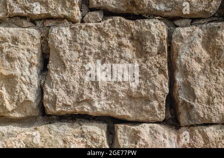 Toile de fond de texture de mur de pierre - parement en pierre grise avec des pierres de différentes tailles Banque D'Images