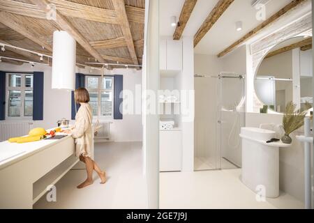Femme cuisant des aliments sains dans une cuisine moderne Banque D'Images