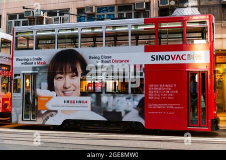 Tram annonçant le vaccin Sinovac pour la pandémie de Covid-19, Hong Kong, Chine. Banque D'Images