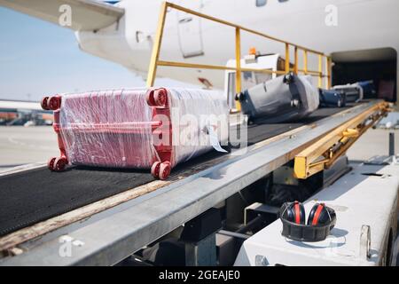 Chargement des bagages dans l'avion. Valises sur le convoyeur à l'avion. Banque D'Images