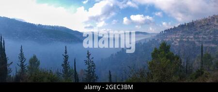 Tôt le matin vue sur les collines dans la jupe de Jérusalem montrant les vallées remplies de brouillard épais Banque D'Images