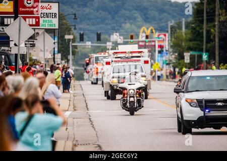 Bloomington, États-Unis. 18 août 2021. Les spectateurs de la rue W. Morgan paient leurs respects lors de la procession funéraire du ambulancier Brandon Staley à Spencer, Indiana. Staley est mort d'une crise cardiaque alors qu'il travaillait comme ambulancier pour le EMS du comté d'Owen (Emergency Medical Services). Staley venait de répondre à un accident de véhicule et était dans une ambulance avec des survivants de l'accident les aidant sur le chemin d'un hôpital quand il lui-même est tombé malade. Crédit : SOPA Images Limited/Alamy Live News Banque D'Images