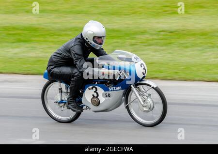 1964 Suzuki RM50 moto qui monte sur la piste de montée de la colline à l'épreuve de course automobile du Goodwood Festival of Speed 2014. Banque D'Images