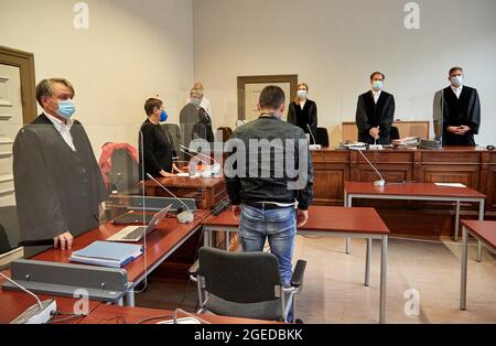 19 août 2021, Hambourg: L'accusé de tentative de meurtre (4e de droite), son avocat Rasul Özpek (l) et les juges Mme Witzke (3e de droite), Thees Willemer (2e de droite) et Christian Lismann (r) se trouvent dans la salle d'audience avant le début du procès. Le défendeur, âgé de 32 ans, aurait tenté de se casser dans des arbres de jardin le 27.1.2021. Quand une femme officier civil a pris conscience de lui, il aurait frappé sa tête avec un fer à angle lourd. Lorsque la collègue de l'officier civil s'est jointe à elle, l'agresseur aurait laissé aller d'elle et lui aurait frappé de coups de poing. L'enfant de 32 ans est chargé de deux comptes de la batterie Banque D'Images