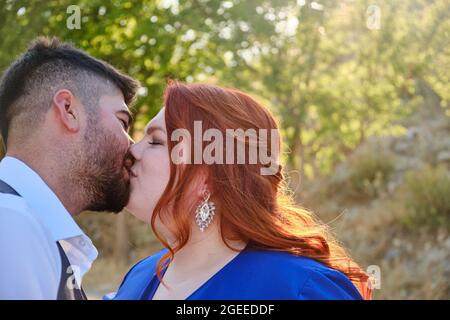 Couple hétérosexuel de race mixte embrassant à l'extérieur Banque D'Images