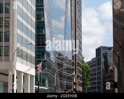 Londres, Grand Londres, Angleterre, 10 août 2021 : gros plan d'un bâtiment à façade de verre sur la rue Victoria avec l'Union Jack à proximité. Banque D'Images