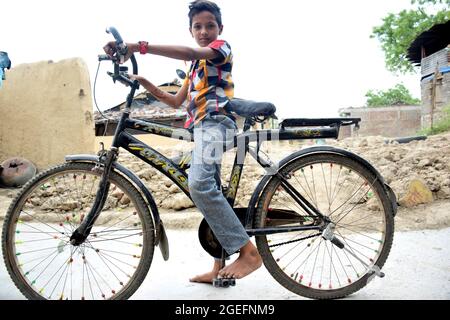 L'enfant rural indien est blissful avec son vélo Banque D'Images