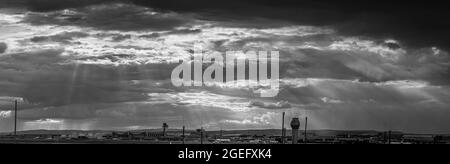 Panorama en noir et blanc de l'aéroport de francfort contre un ciel impressionnant avec des formations de nuages sauvages et des rayons du soleil Banque D'Images