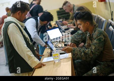 Kaboul, Afghanistan. 18 août 2021. Une marine américaine affectée à la 24e unité expéditionnaire maritime traite les civils afghans pour évacuation à l'aéroport international Hamid Karzaï dans le cadre de l'opération alliés refuge le 18 août 2021 à Kaboul, en Afghanistan. Credit: Planetpix/Alamy Live News Banque D'Images