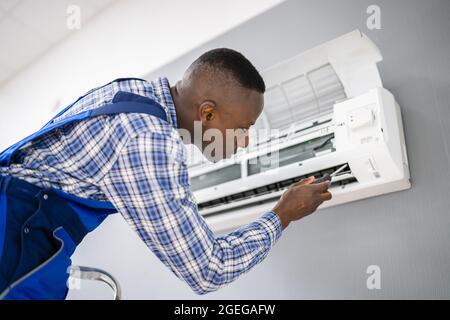 Technicien en électricité du secteur, réparation de l'appareil de climatisation Banque D'Images