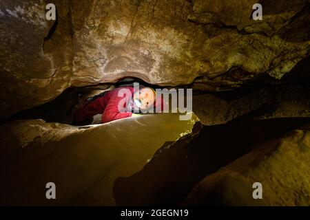Villard de Lans (sud-est de la France) 2021/23/23: Groupe de spelunking dans la grotte "grotte Roche". Passage étroit Banque D'Images